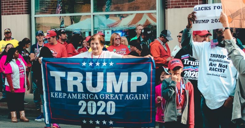 woman holds trump flag, campaign slogan training