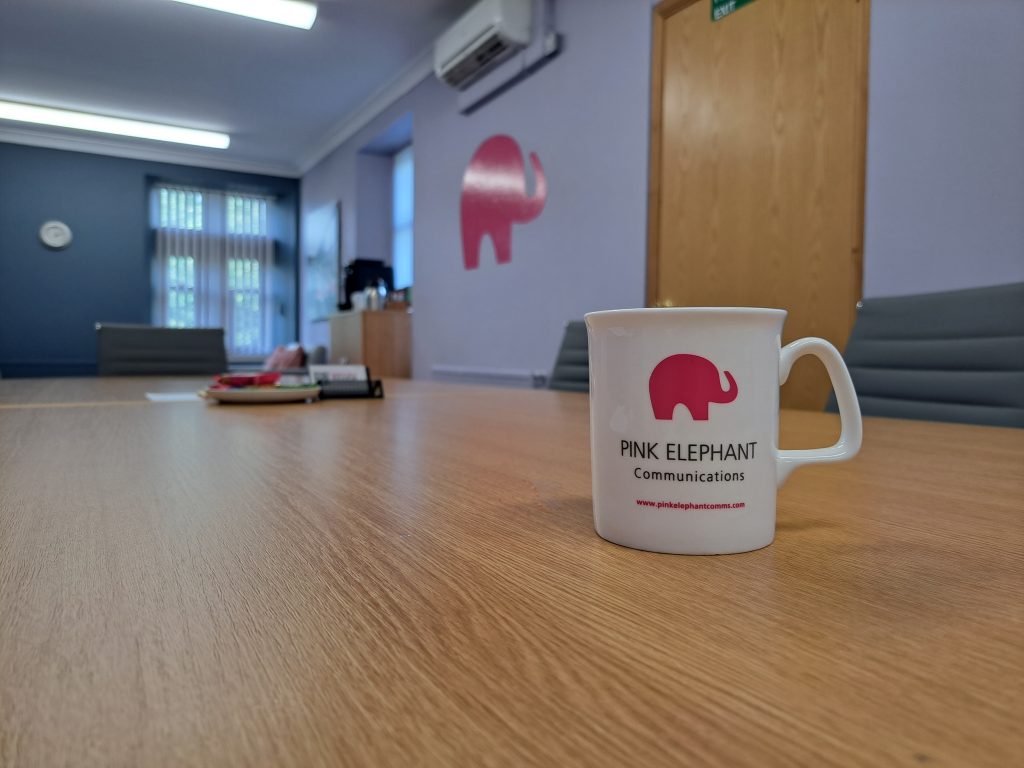 storytelling training uk, pink elephant mug on the table