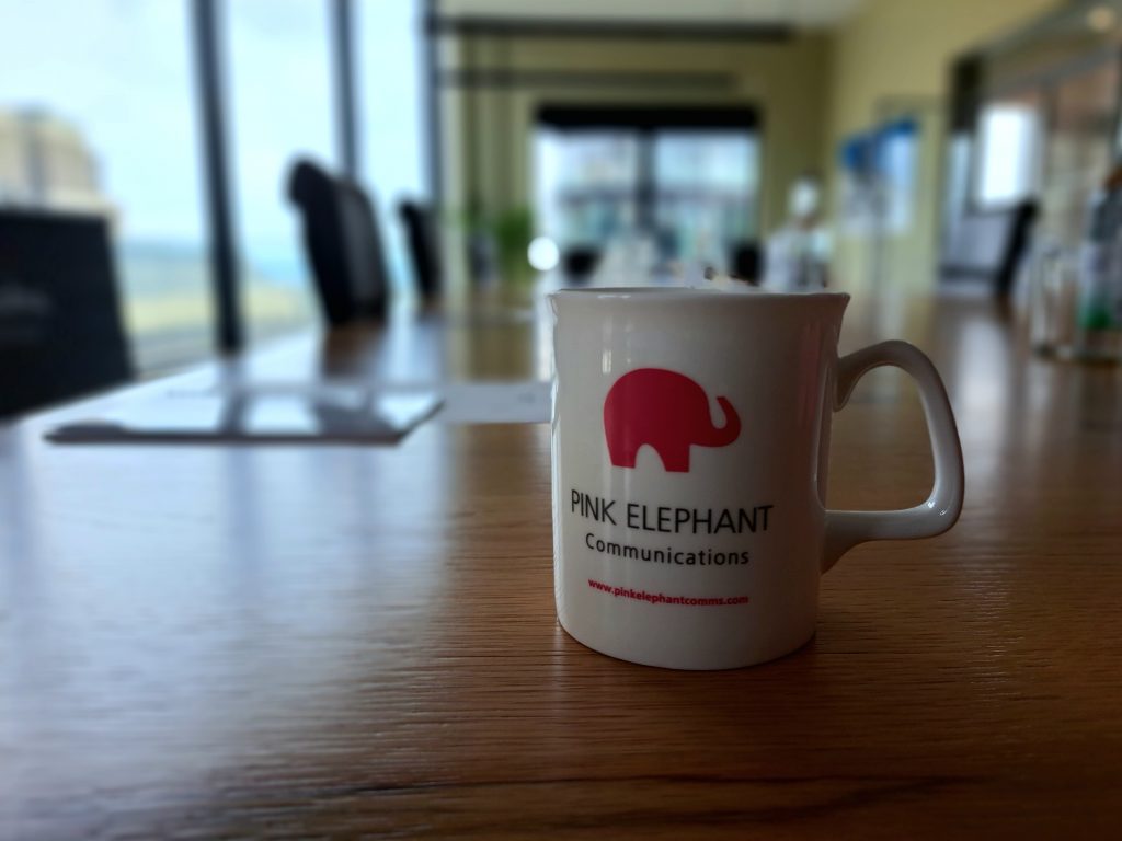 Presentation skills training London, pink elephant mug on a board room table