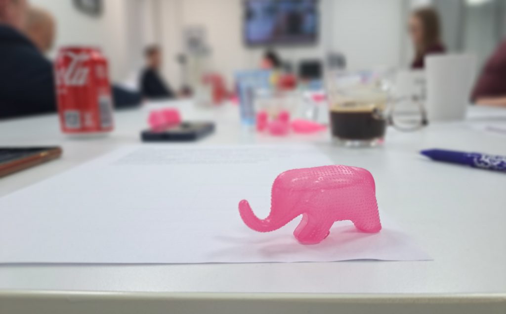 Public speaking training, a pink elephant on a table